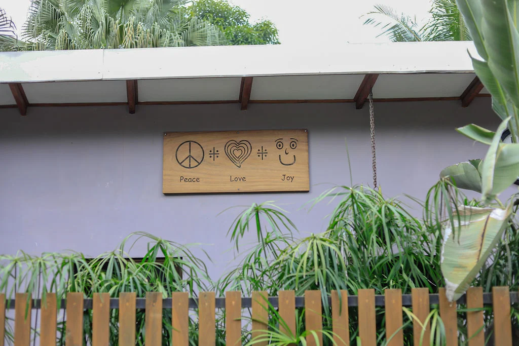Peace, Love and Joy sign among tropical plants
