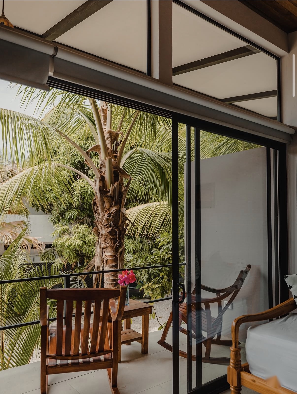 Balcony chairs overlooking palm trees from the studio