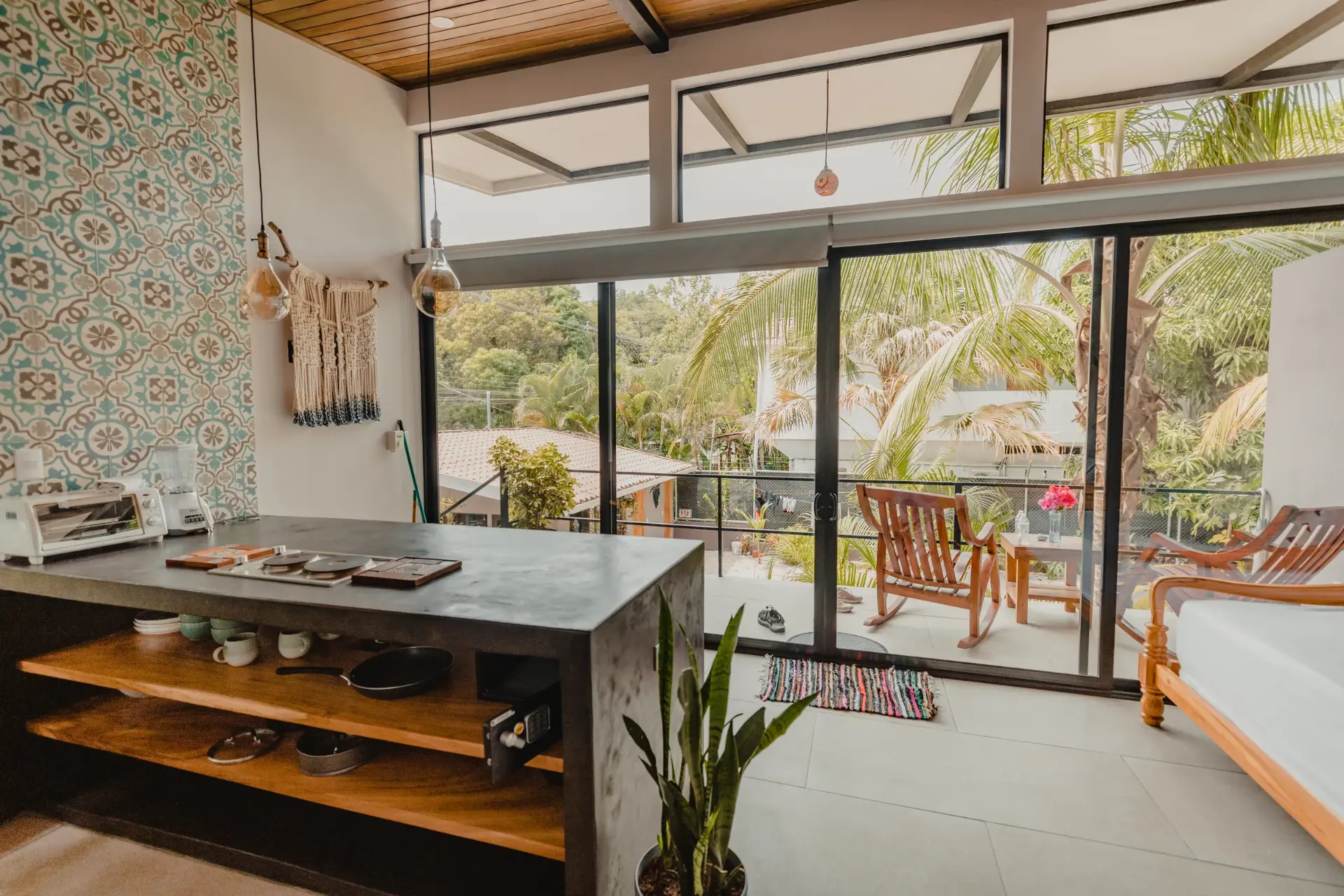 Open-plan studio with tropical balcony views