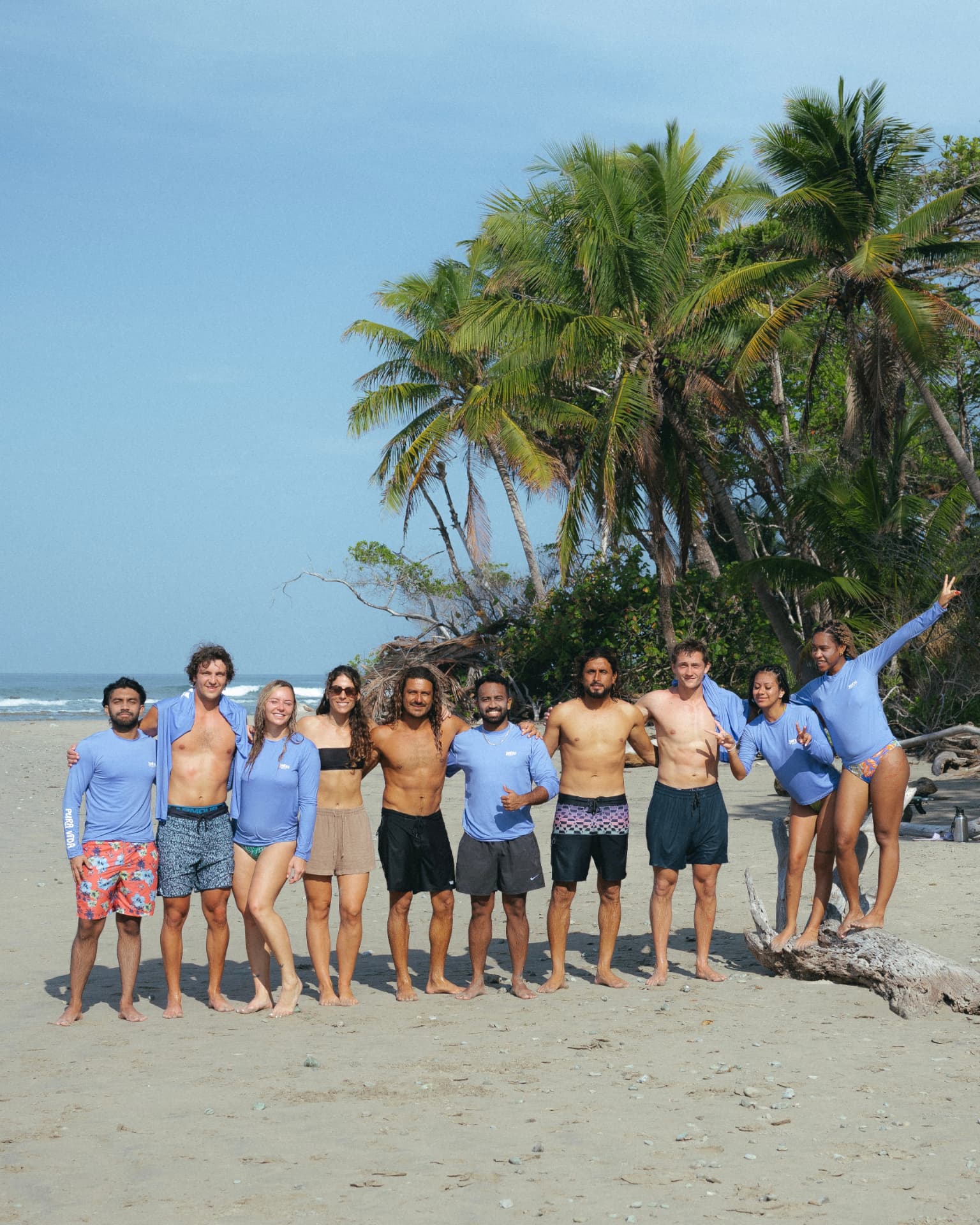 Kahu Surf Club group together on the beach